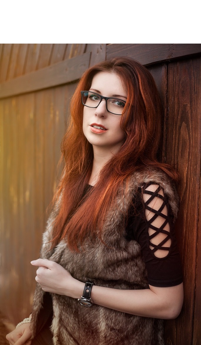 long ginger hair woman with glasses and fluffy outfit