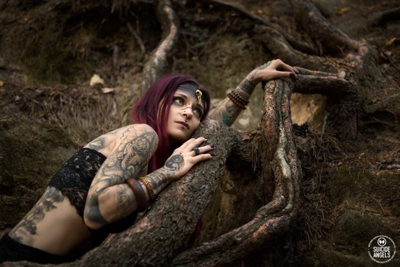 tribal forest tattoo woman on tree, red and pink hair
